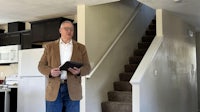 a man standing in front of a house with stairs