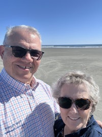 a man and woman are taking a selfie on the beach